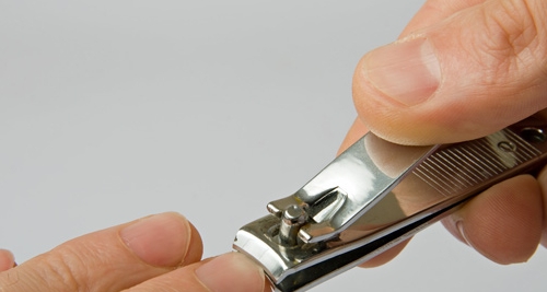 here is a man cuttiing hus fingernails
