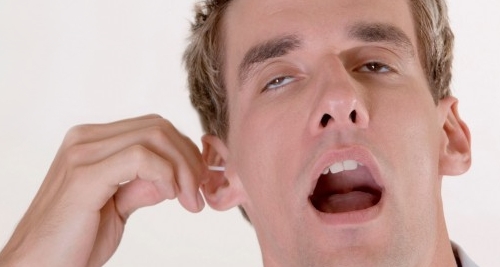 Here is a man cleansing his ear with a Q-tips