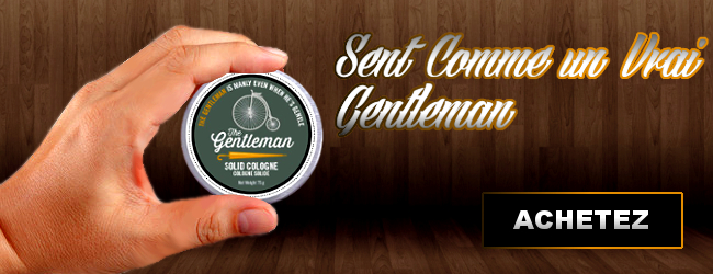 Une main tenant une cologne solide a l'odeur de gentleman dans un fond en bois avec texte ''sent comme un vrai gentleman'' et un bouton ''Achetez''
