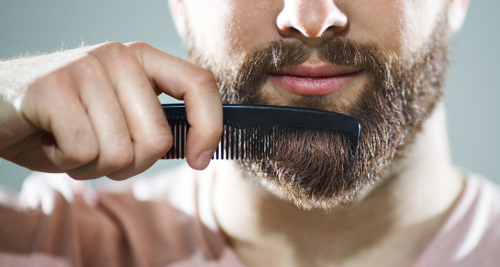 Man combing his beard