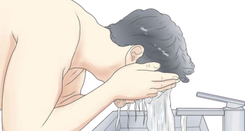 Here is a man cleaning his face with warm water before the shaving.