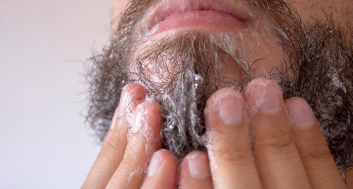 Man washing his beard