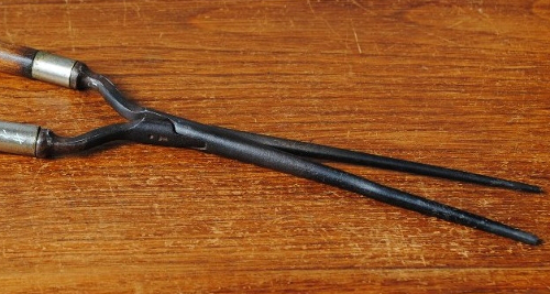 Here is an antique iron mustache curler